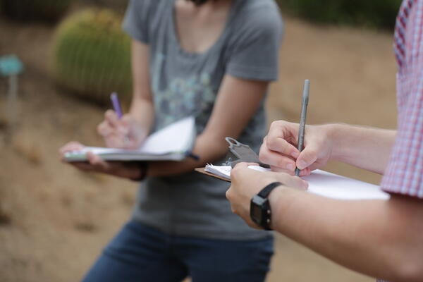 Students taking notes in Botanic Gardens